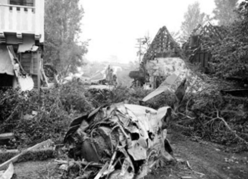 Debris from the crash of Howard Hughes' XF-11 reconnaissance plane lies scattered between two houses damaged after the plane's test flight on July 7, 1946. Hughes was seriously injured when the landing gear jammed.